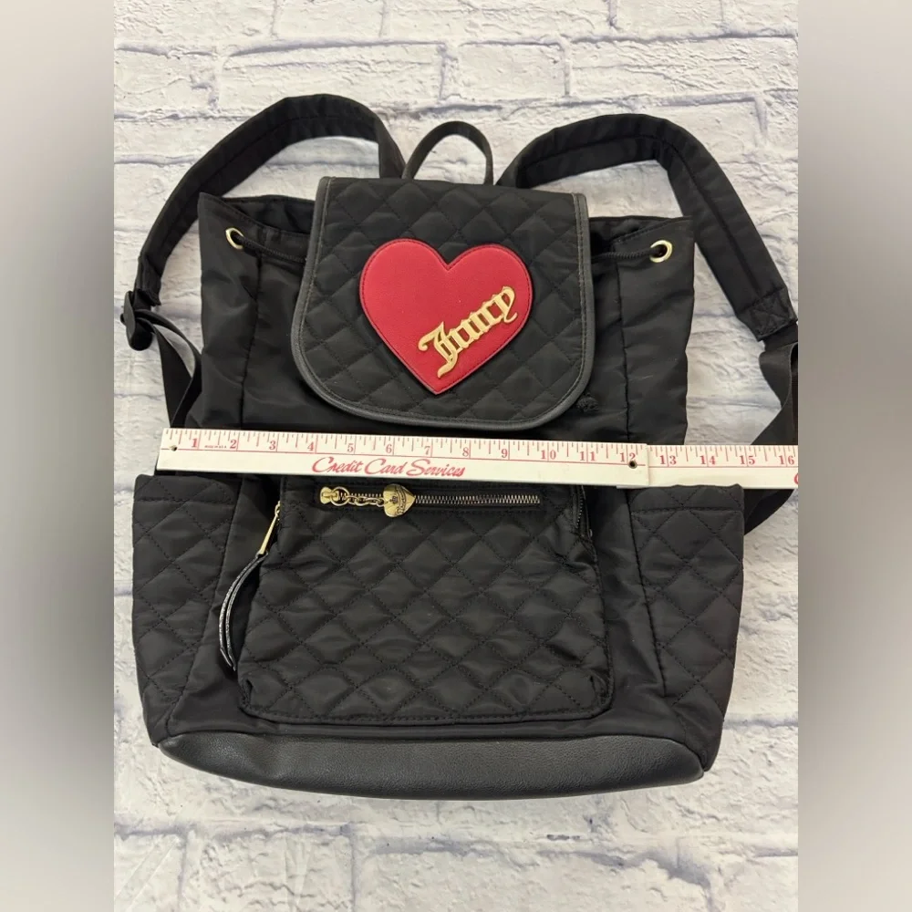 Juicy Couture black quilted backpack heart motif, drawstring top.